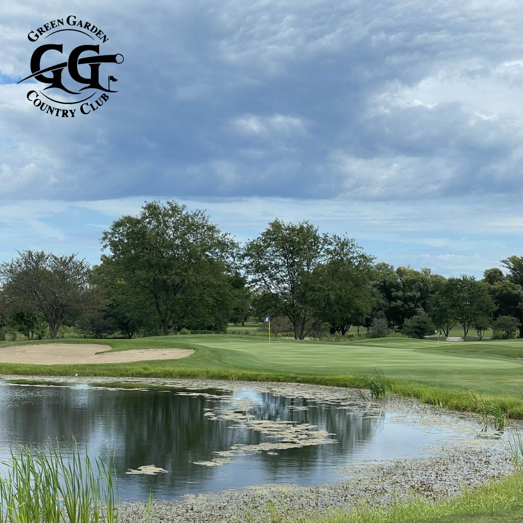 image of a pond in front of a green with a sand trap on the left side